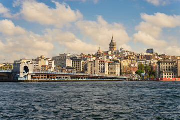 Fototapeta na wymiar City view of Istanbul skyline, Turkey, from the Bosporous overlooking Galata Bridge with traditional fish restaurants and Galata Tower in the background