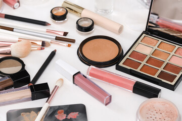 make-up tools and cosmetics on white table. Decorative cosmetics, brushes, eyes shadow, pencils with foundation on dressing table or beauty salon