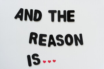 and the reason is (ellipsis created with three mini paper hearts) black chalk letters