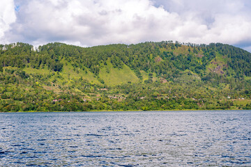 Scenic view of lake againts mountain and sky