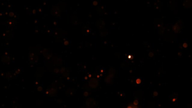 Beautiful loopable falling circle glitter glow red bokeh particles on black background for screen project overlay. 4K seamless loop new year themed background for winter Christmas
