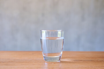 A glass of drinking water on wooden table