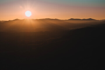 Morning in the Carpathian mountains. Autumn foggy landscape with the sun