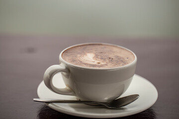 Close up photo of mocha coffee on wooden table.
