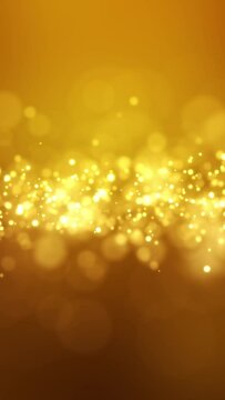 Video animation of golden light shine particles bokeh over golden background - abstract particles background - vertical video
