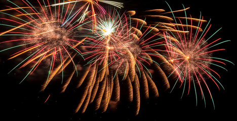 Fireworks - light festive show. Bright rays of light on black background of night sky. Fireworks.