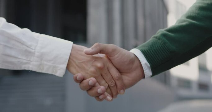 Closeup Partners Shaking Hands on Meeting in City. Professional Businesspeople near Office Building. Teamwork and Agreement Concept 
