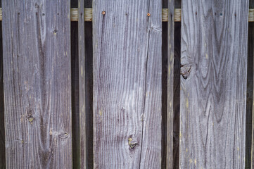 Decaying Wooden Picket Fence with Faint Remnants of Yellow Paint.