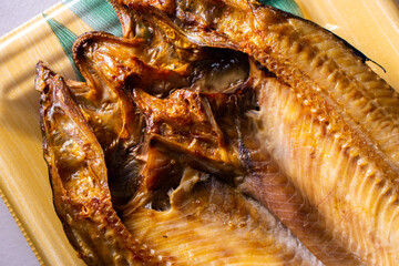 Closeup Japanese Aji no Hiraki (dried and salted horse mackerel) in a food container.