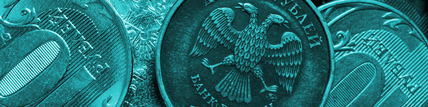 Coins of 10 ten rubles close-up. Money banner. Turquoise tinted headline on an economic, financial or banking theme in Russia. Top view Russian small money. Macro