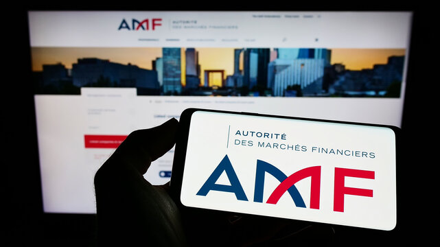 Stuttgart, Germany - 09-11-2022: Person holding cellphone with logo of French regulator Autorite des Marches Financiers (AMF) on screen in front of webpage. Focus on phone display.
