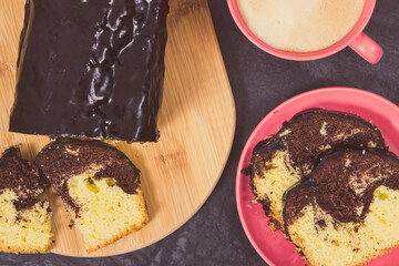 Fresh baked yeast cake with cocoa, cup of cappuccino. Delicious dessert. Vintage photo