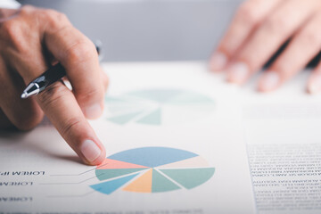 Businessmen analyze market reports with statistics from charts and graphs, managing business and financial strategies, professional analysts view investment information, consulting and presentations.
