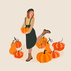 Young woman picking pumpkins at autumn garden.