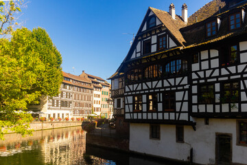 Fototapeta na wymiar Picturesque view of old French town of Strasbourg with canals and ancient fachwerk houses at sunny summer day