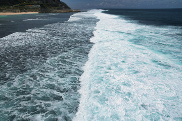 Big waves breaking on the beach - clear beautiful turquoise blue ocean sea and clouds in the sky - Bali