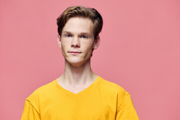 cute man posing in yellow tank top on pink background