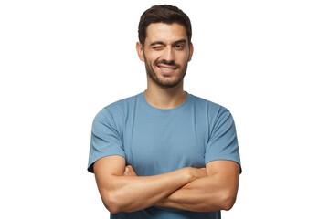 Handsome young man in blue t-shirt, with crossed arms smiling and winking, looking at camera - obrazy, fototapety, plakaty