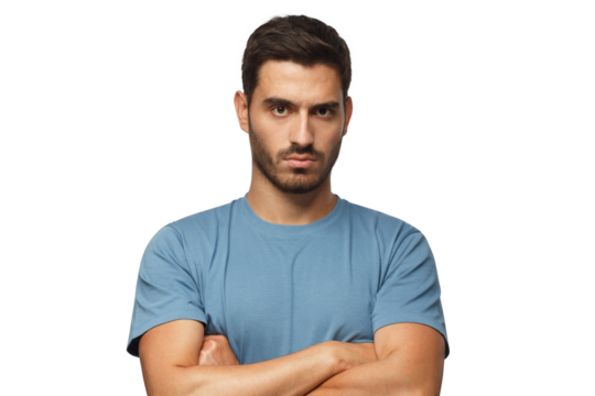 Young man in blue t-shirts tanding with arms crossed and serious concentrated face at camera, looking aggressive