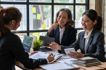 Business meeting concept brainstorming financial analyst financial report on graph document during corporate meeting discussion Demonstrates successful teamwork.