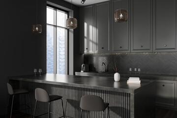 Grey kitchen interior with bar countertop and chairs, kitchenware and window