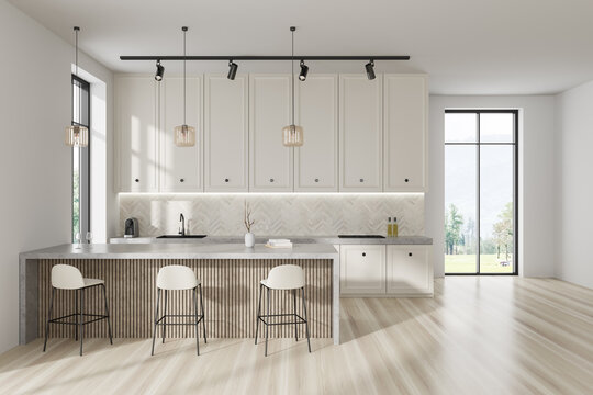 Light kitchen interior with bar island and seats, shelves and panoramic window