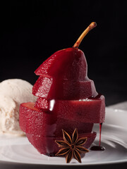 Composition with sweet poached pears and ice cream on light background dark
