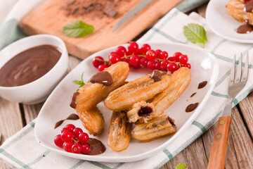 Mini churros with chocolate dipping sauce.
