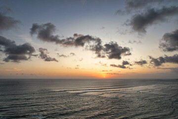 Beautiful red orange sunset sunrise over the ocean sea with waves 
