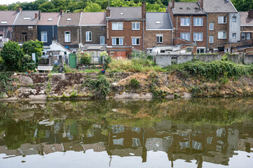 Fototapeta na wymiar Farciennes, Wallon Region, Belgium, Residencial houses reflecting at the banks of the River Sambre