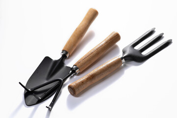 Gardening tools, shovel, fork, rake on a white background