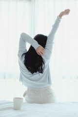 woman doing exercise after wake up with coffee mug