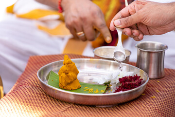 Obraz na płótnie Canvas South Indian Tamil wedding ceremony ritual items and hands close up