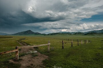 Fototapeta na wymiar Green fields and slopes of the Altai Mountains