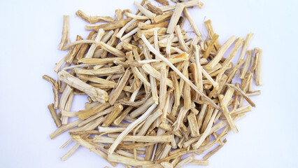 Close up of Ayurvedic herb Satavari or kurilo or Asparagus racemosus isolated on white in a glass bowl.