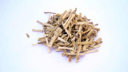 Close up of Ayurvedic herb Satavari or kurilo or Asparagus racemosus isolated on white in a glass bowl.