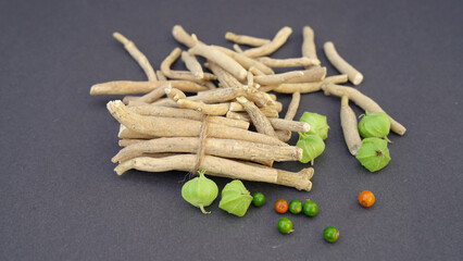 Ashwagandha Dry Root Medicinal Herb with Fresh Leaves, also known as Withania Somnifera, Ashwagandha, Indian Ginseng, Poison Gooseberry, or Winter Cherry. 