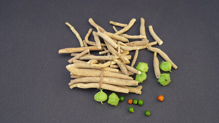 Ashwagandha Dry Root Medicinal Herb with Fresh Leaves, also known as Withania Somnifera, Ashwagandha, Indian Ginseng, Poison Gooseberry, or Winter Cherry. 