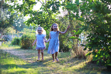Fototapeta premium Children walk in the summer in nature. Child on a sunny spring morning in the park. Traveling with children.