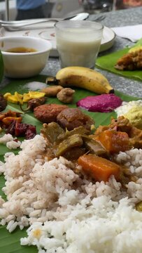A wide varieties of indian kerala dishes on a banana leaf