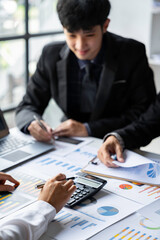The business team that operates on the table checking data, Concept financial transactions online of a businessman, Financier being checked about financial transactions past computer with teamwork.