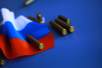Russian flag and bullet casings on the table. Background concept Russian army.