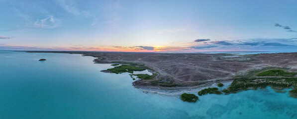 Fototapeta na wymiar Evening on the lake. Sunset on the lake view from the quadcopter. Aerial photography on the lake