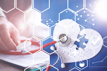 Stethoscope, puzzle heart, prescriptions. Double exposure in composition. Doctor`s desk in the clinic's office.