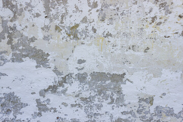 Very damaged aged white plaster wall background texture