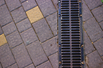 urban paving slabs with yellow bricks and water canal