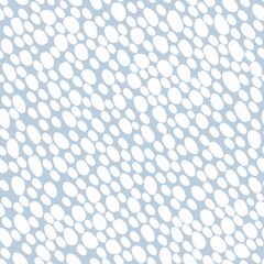 Chaotic white oval dots on light blue background. Raster seamless pattern with snowflakes. Monochrome polka dot background.