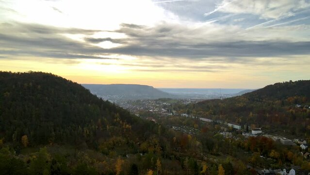 Morning view of sunrise in autumn. Scenic hilly aerial view of city Jena, Germany