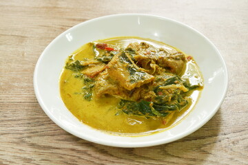 spicy spicy slice stingray fish in coconut milk curry on plate