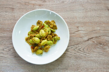 fried pork with flat bean in shrimp paste curry Thai southern food on plate